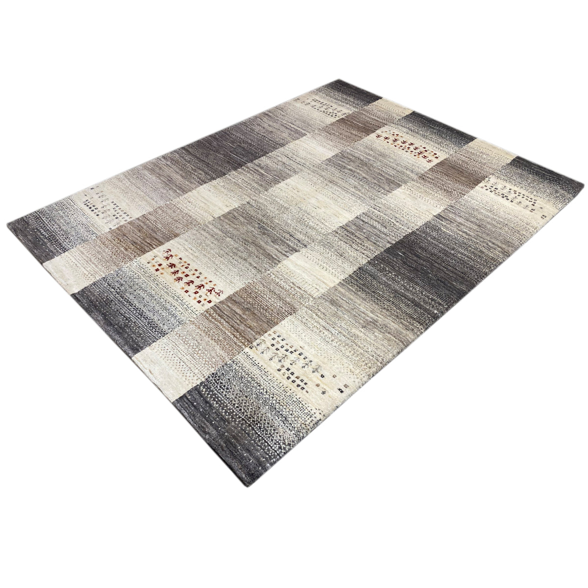 Gabbeh rug in angled view: diamond and block stripes in gray and cream, with red accents