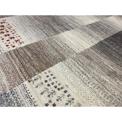 Gabbeh rug close-up: textile texture, block pattern in cream and gray with red motifs