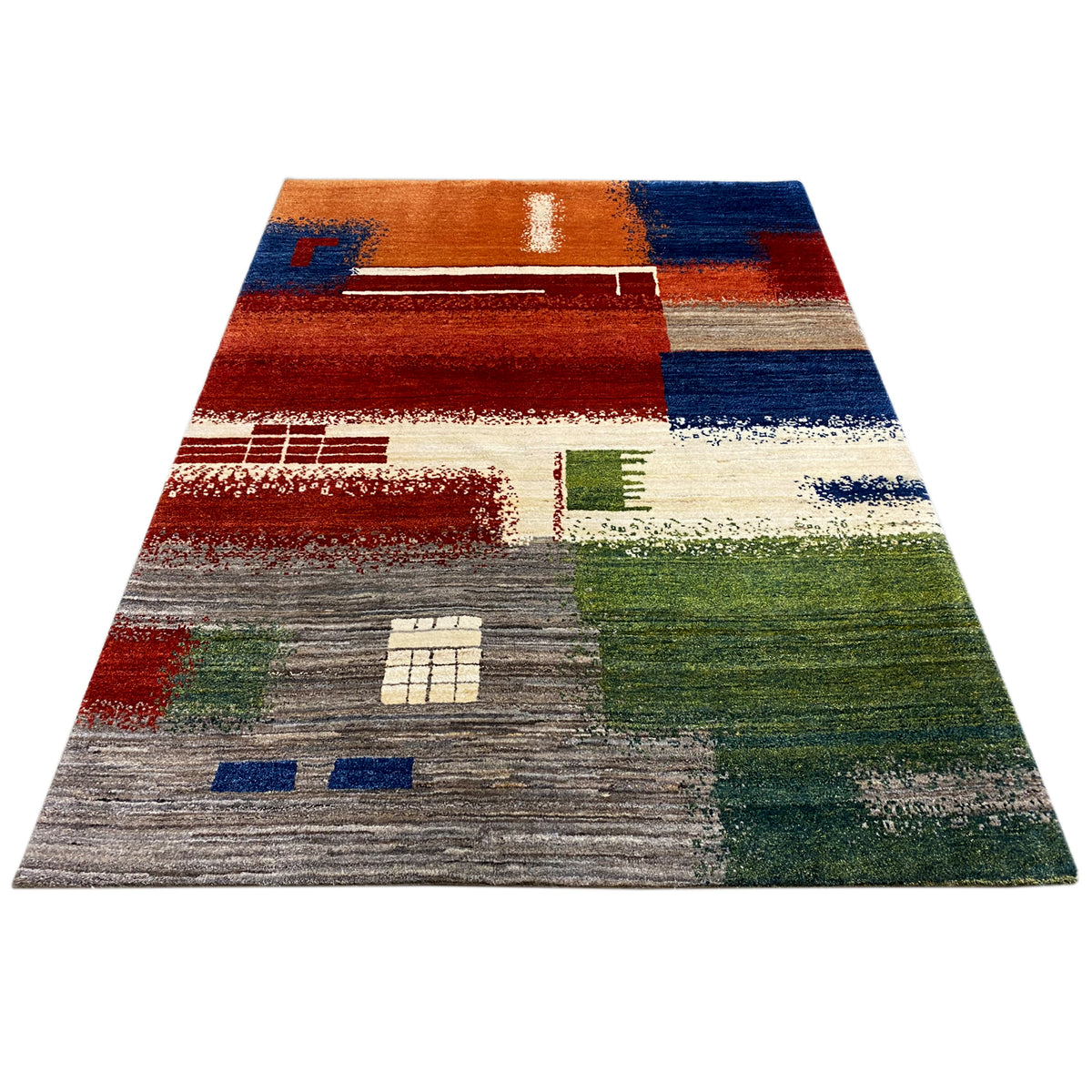 Gabbeh rug with an abstract patchwork pattern in brown, blue, green, and cream, laid out