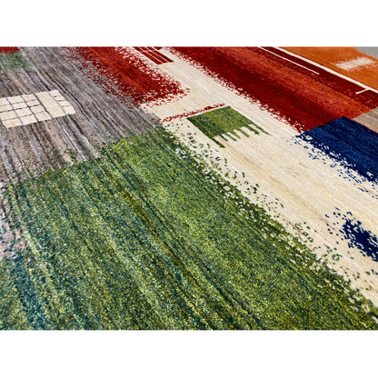 Gabbeh rug detail with geometric bars and dots in red, blue, green, and cream