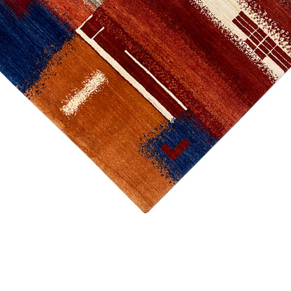 Gabbeh rug with a brown stripe pattern, white lines, and blue accents, close-up detail