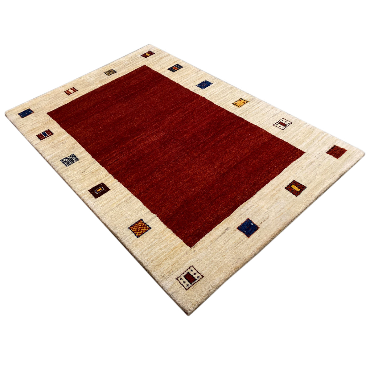 Rug in a diagonal pattern: red center, beige border with small colorful squares