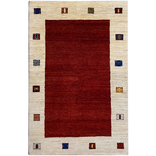 Gabbeh rug with a red rectangle, beige border, and colorful squares