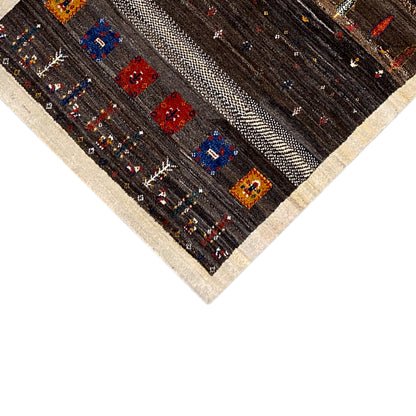 Carpet detail: dark brown background with beige decorative stripes and red/blue squares