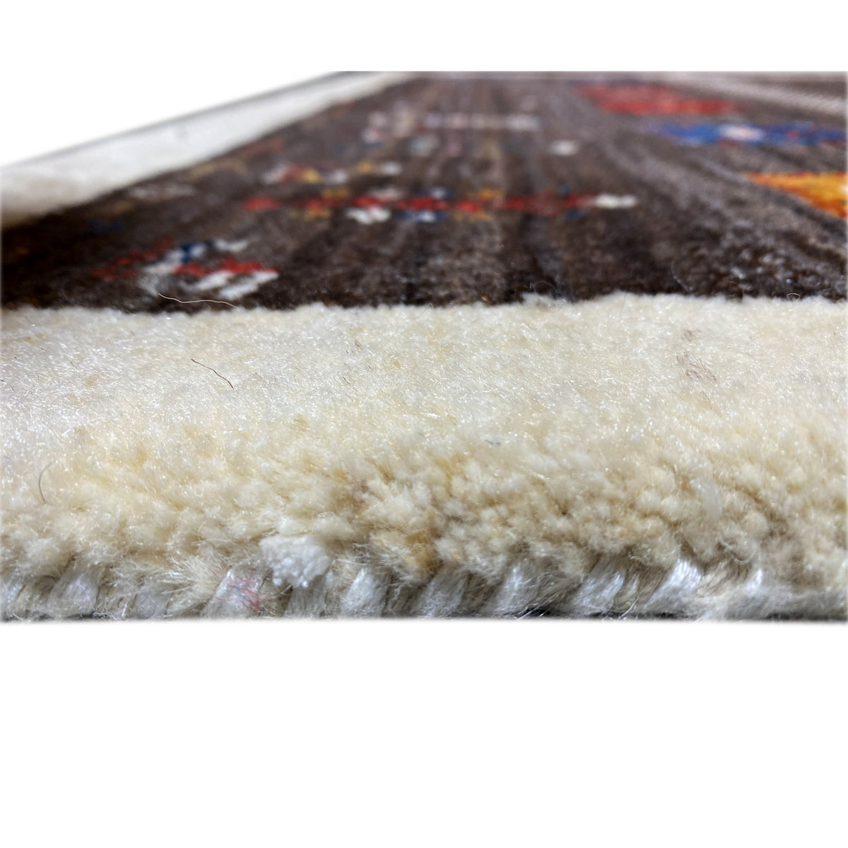 Carpet edge with beige pile; above it, a dark patterned area.