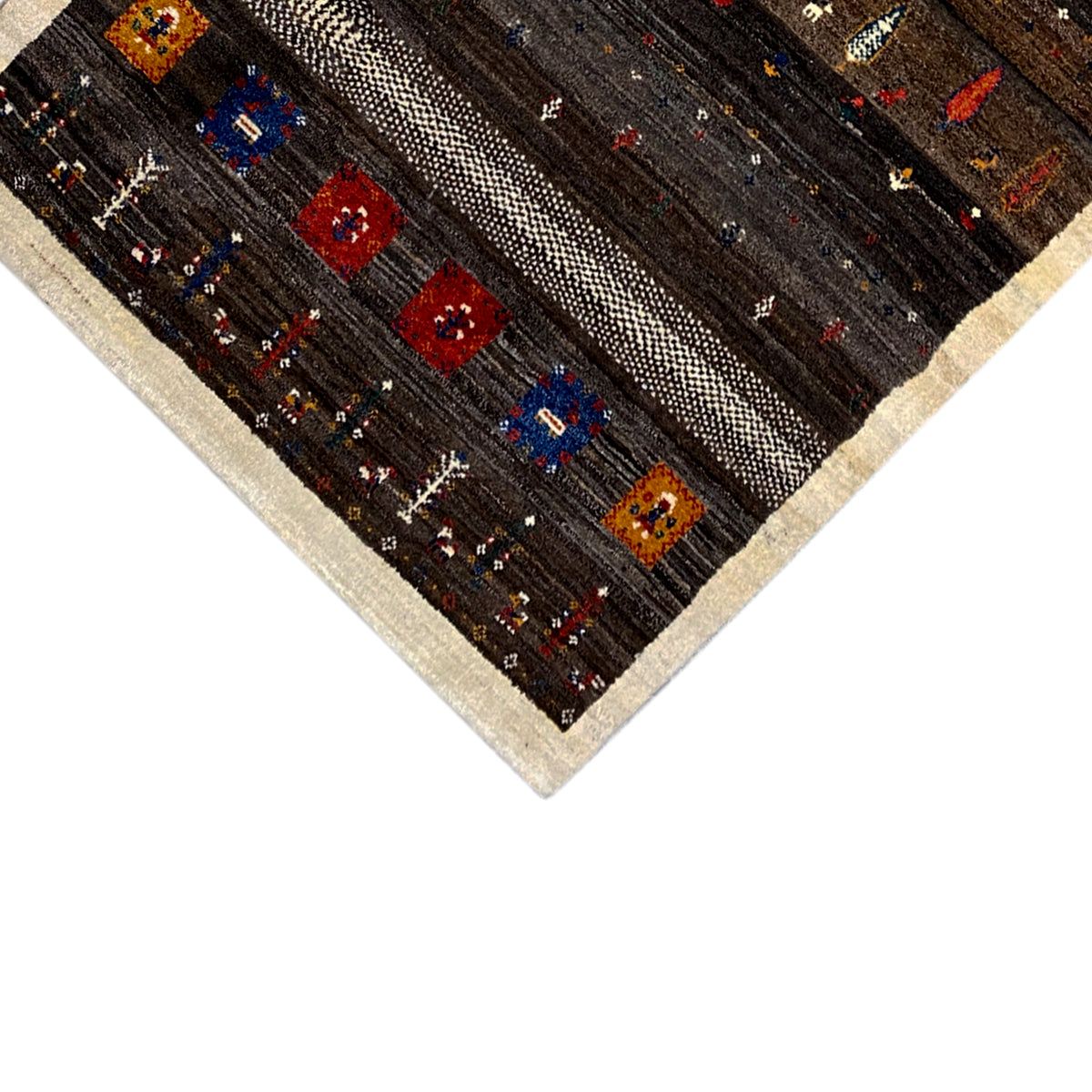 Close-up of the rug: beige border band and colorful square patterns on a dark background.