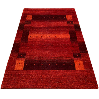 Rectangular red Gabbeh rug with a flat pattern featuring dark elements
