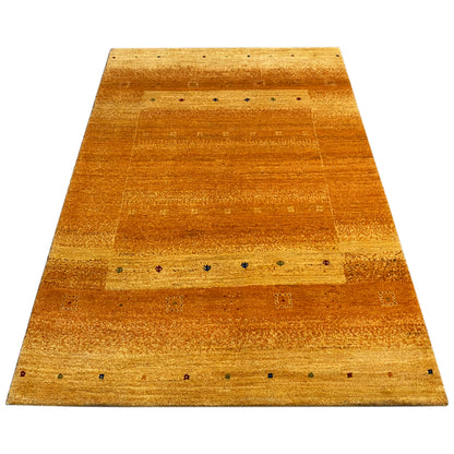 Honey-brown Gabbeh rug with a wide border and striped sections with dots