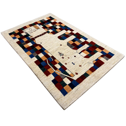 Gabbeh rug 180x119 cm, diagonal view: cream-colored pile with a multicolored checkered pattern and border