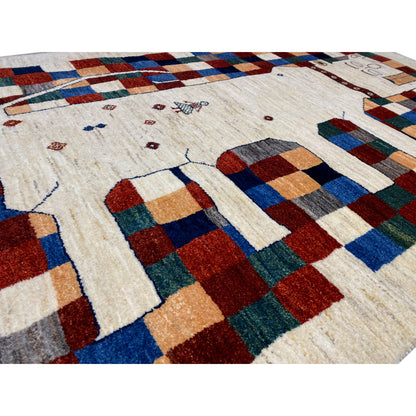 Gabbeh rug detail: cream-colored pile with colorful squares in red, blue, green, and beige