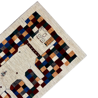 Gabbeh rug 180x119 cm, detail view with a cream-colored background, colorful checkered elements, and a border