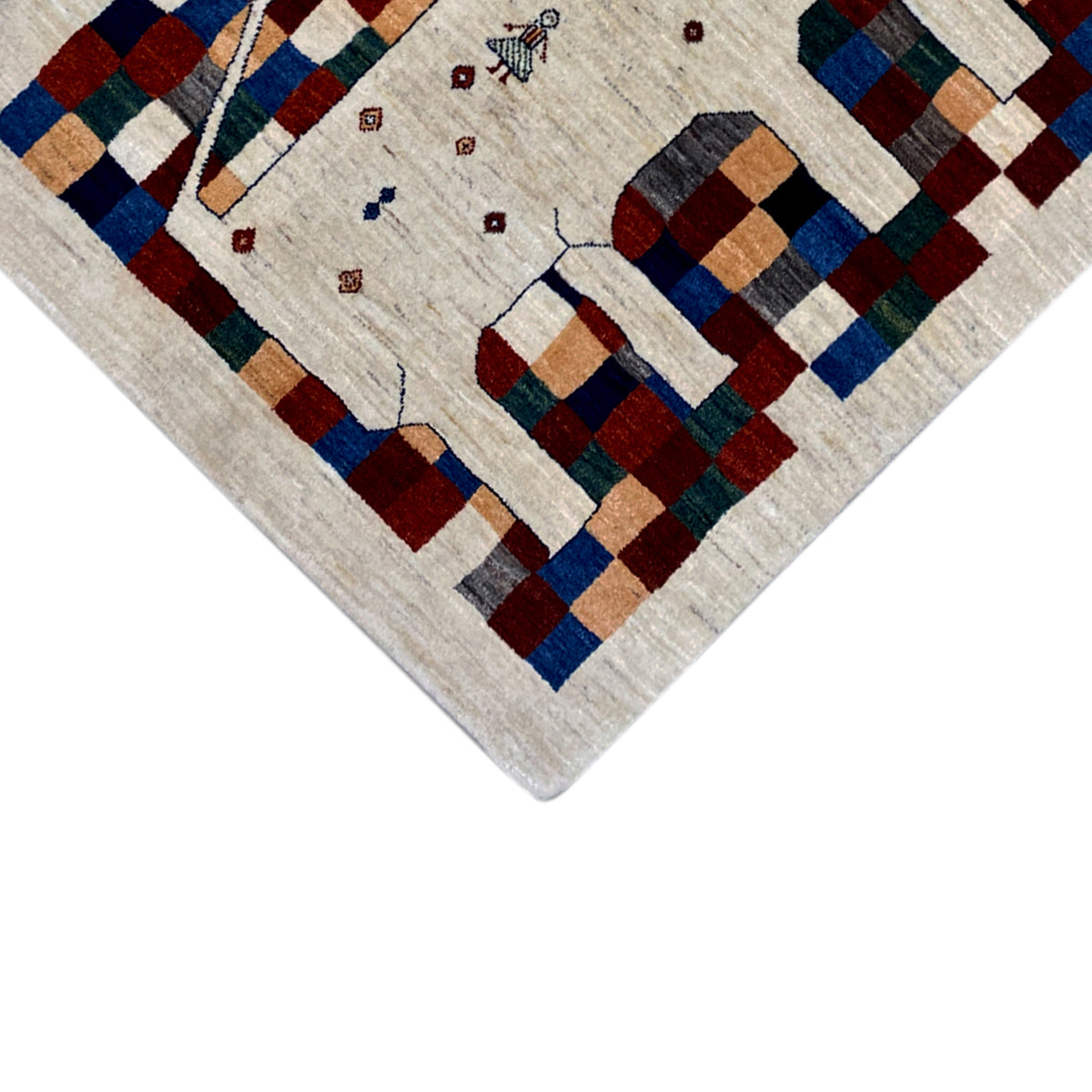 Gabbeh rug corner view: cream-colored pile with geometric squares in blue, red, and green