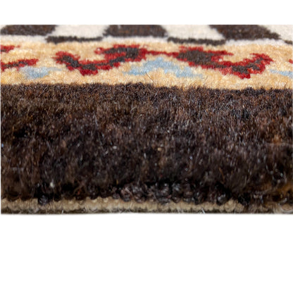Rug edge in detail: dense pile with a brown border and multicolored stripes at the top