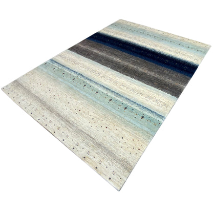 Gabbeh rug with visible edge: light blue-gray stripes, fine textured dots