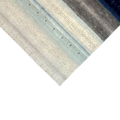 Gabbeh rug corner: light beige with blue-gray stripes and textured dots