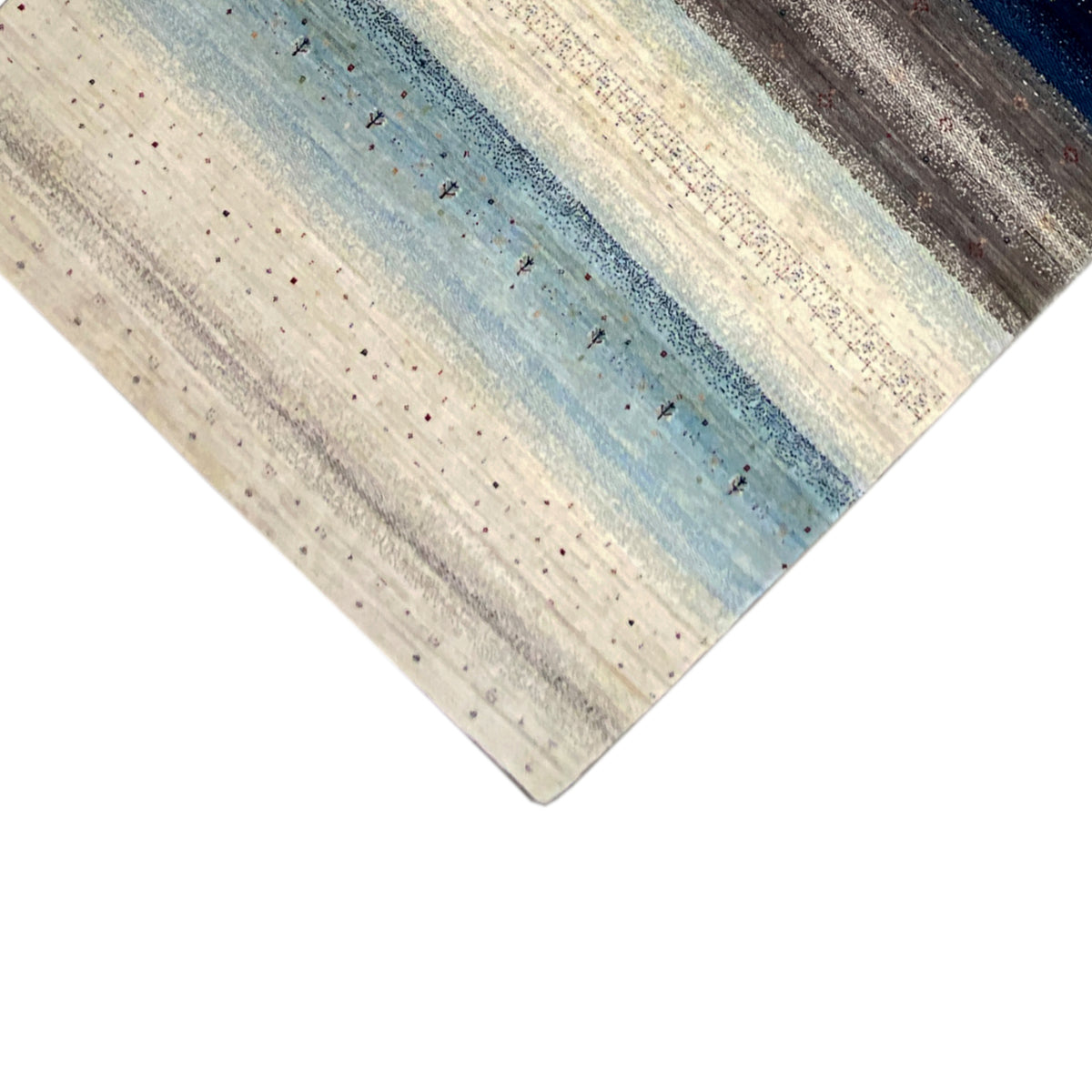 Gabbeh rug corner view with a straight edge and stripes in beige, blue, and gray
