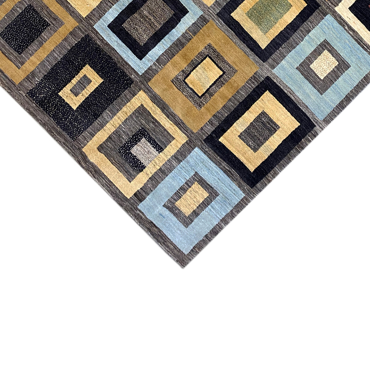 Close-up of the carpet pattern with dark blue, yellow, and light blue squares