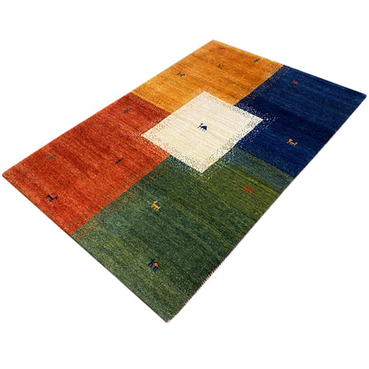 Gabbeh rug (184x124 cm) with warm red, orange and blue blocks, a green field and a light center
