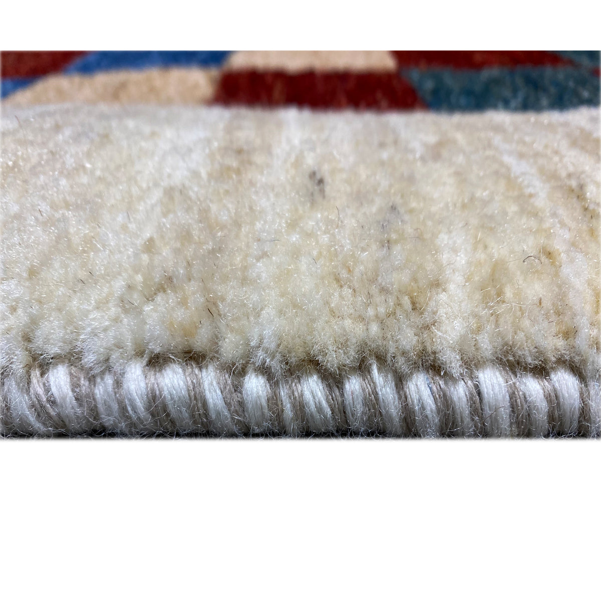 Gabbeh rug 182 x 120 cm, close-up of the pile edge with a dense, light wool texture