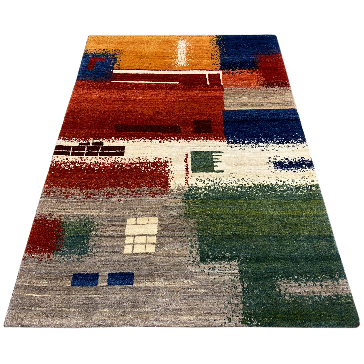 Gabbeh rug 186x125 cm shown at an angle, abstract patchwork pattern in shades of red, blue, and green