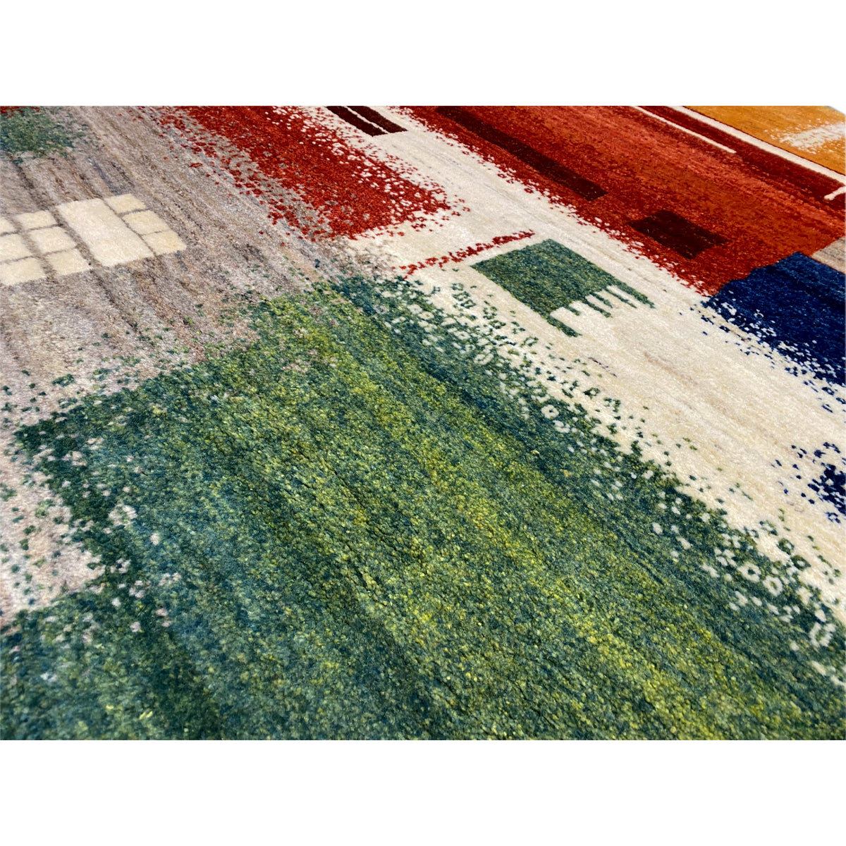 Gabbeh rug 186x125 cm close-up: mixed color patches in green, red, and blue on a light background