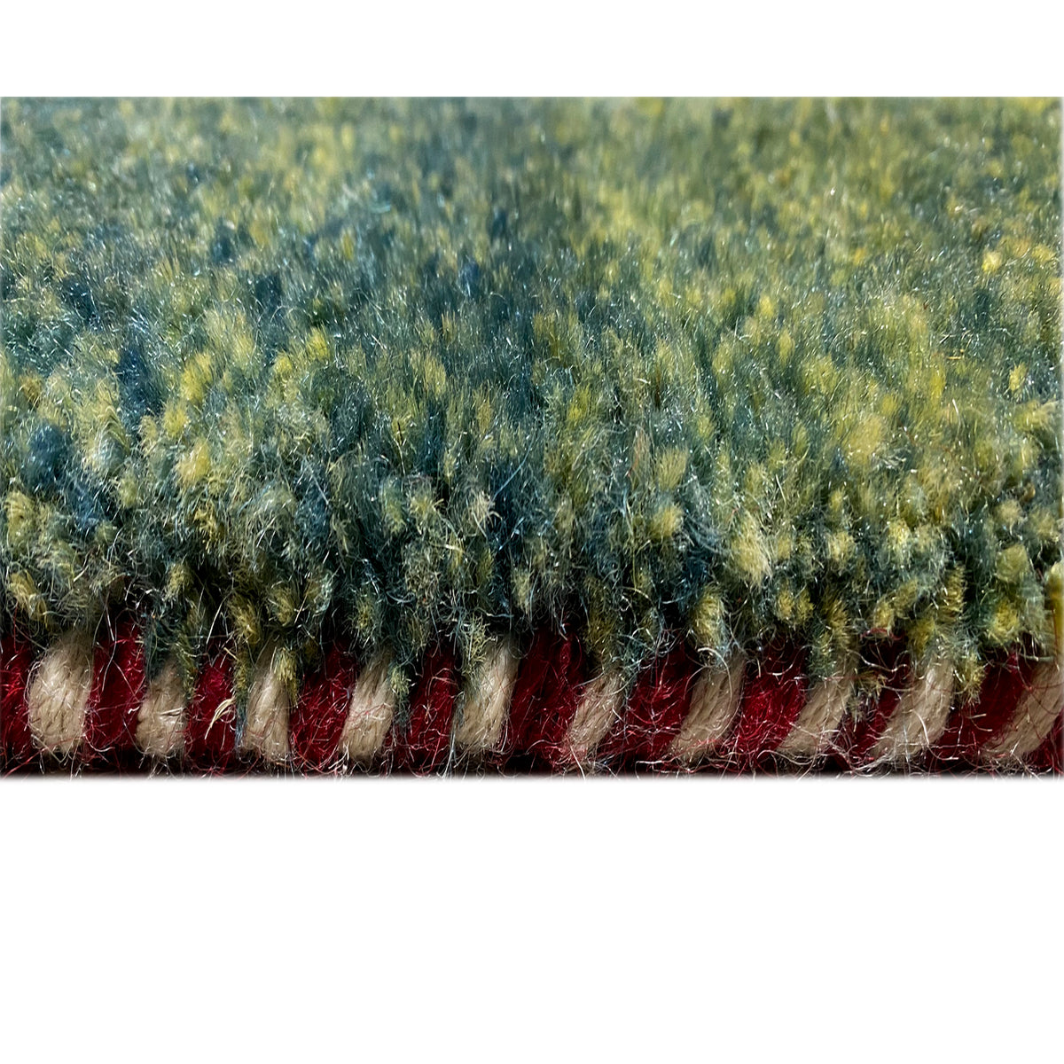 Gabbeh rug 186x125 cm, close-up of the edge: fringes and reddish reverse side visible