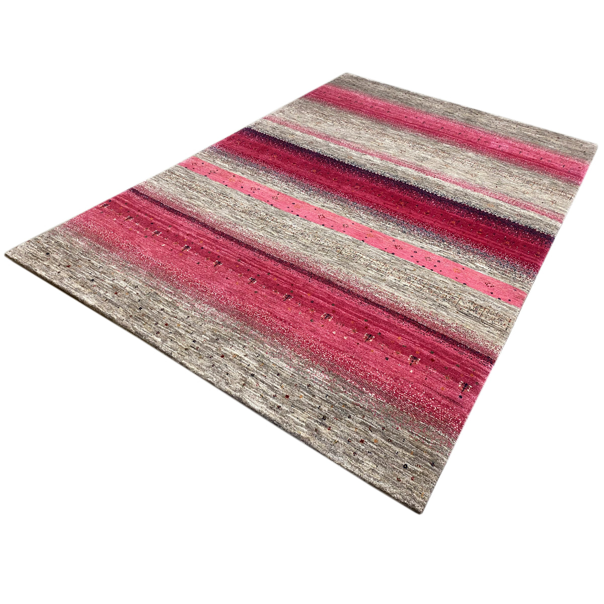 Gabbeh rug with pink and gray stripes, photographed at an angle