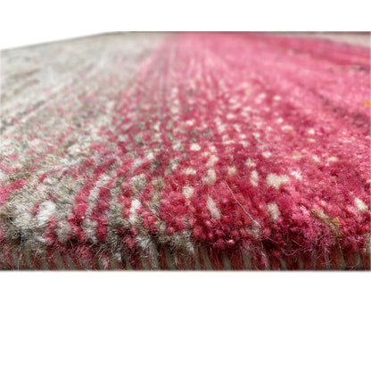 Gabbeh rug detail: pile and edges, pink and gray in a striped pattern