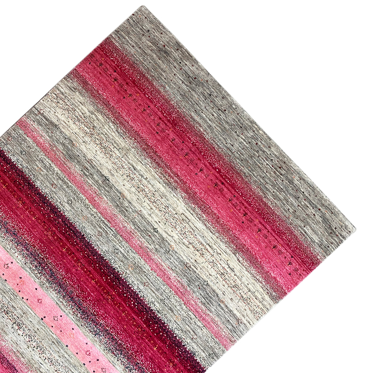 Gabbeh rug viewed from above at an angle: striped look in pink and gray