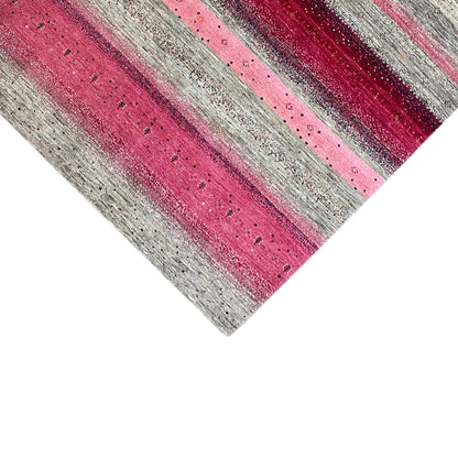 Gabbeh rug close-up: horizontal mix of stripes in pink and light gray