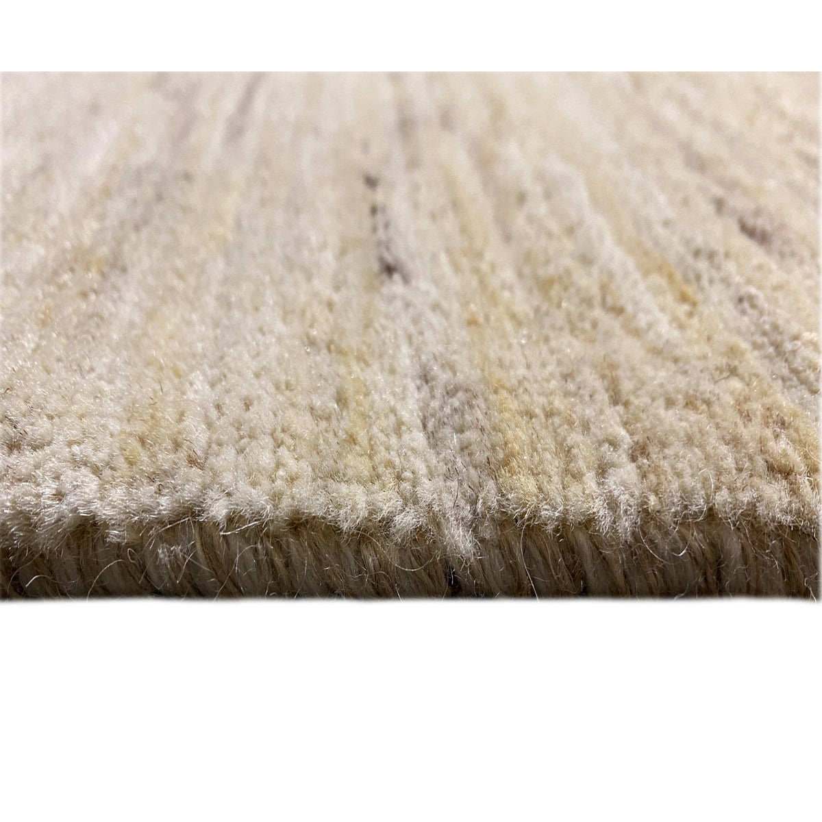 Gabbeh rug close-up of the pile height in light beige, with a dense, soft surface