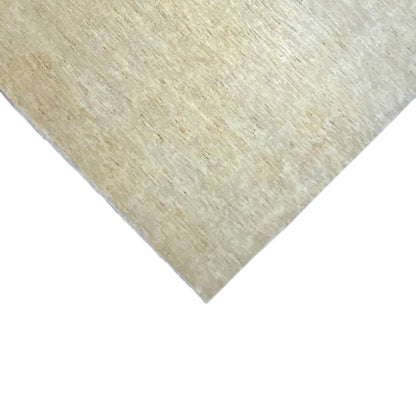Corner of the Gabbeh rug in light beige, with a visibly speckled texture along the edge