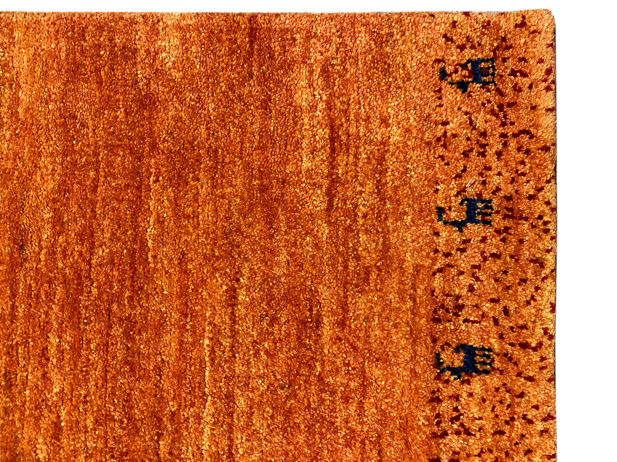 Gabbeh-Teppich 230x172 cm Detailansicht mit orangefarbenem Flor und kleinen dunklen Flecken