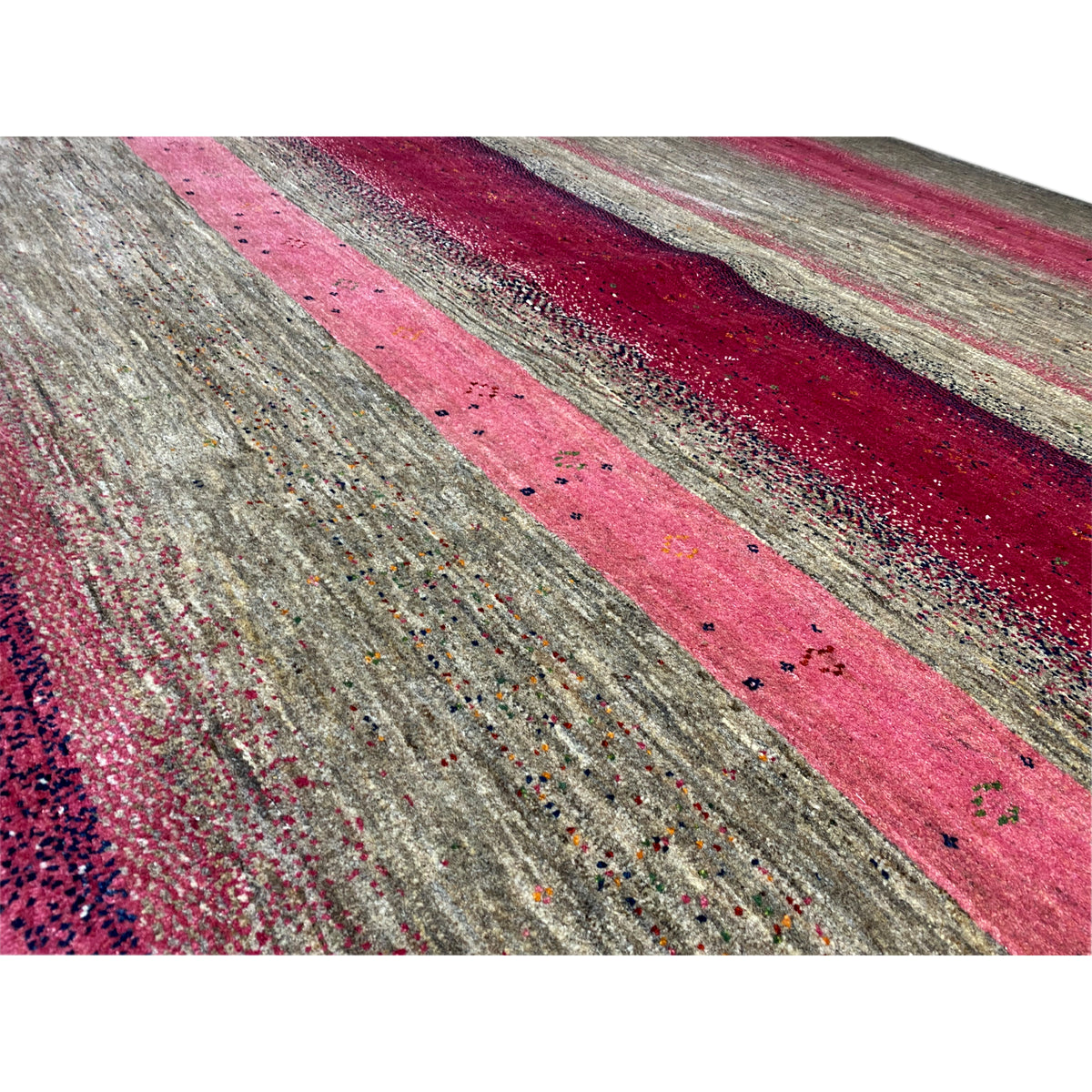 Gabbeh rug detail view: dotted stripe pattern in pink and gray