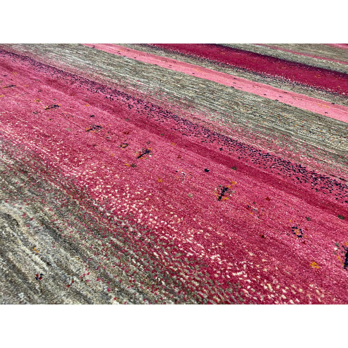 Gabbeh rug close-up: pink area with a grainy, textured surface