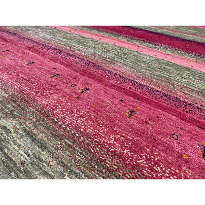 Gabbeh rug close-up: pink area with a grainy, textured surface