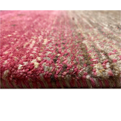 Close-up of a Gabbeh rug at the edge: pile in pink and gray