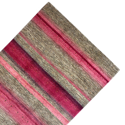 Gabbeh rug from a diagonal overhead view: stripes in shades of pink and gray