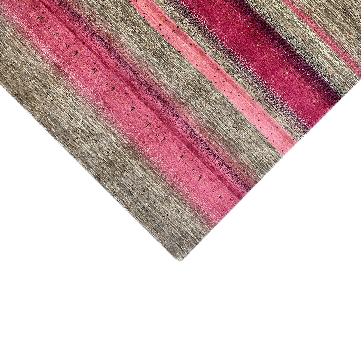 Close-up of a Gabbeh rug: narrow pink and gray stripes on a light pile