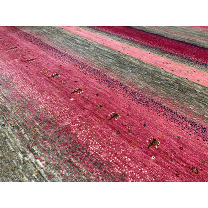 Gabbeh rug detail: mottled fibers, pink and gray with colorful dots