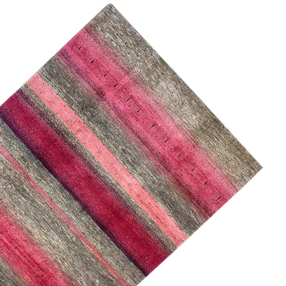 Gabbeh rug close-up: horizontal stripes in pink and gray
