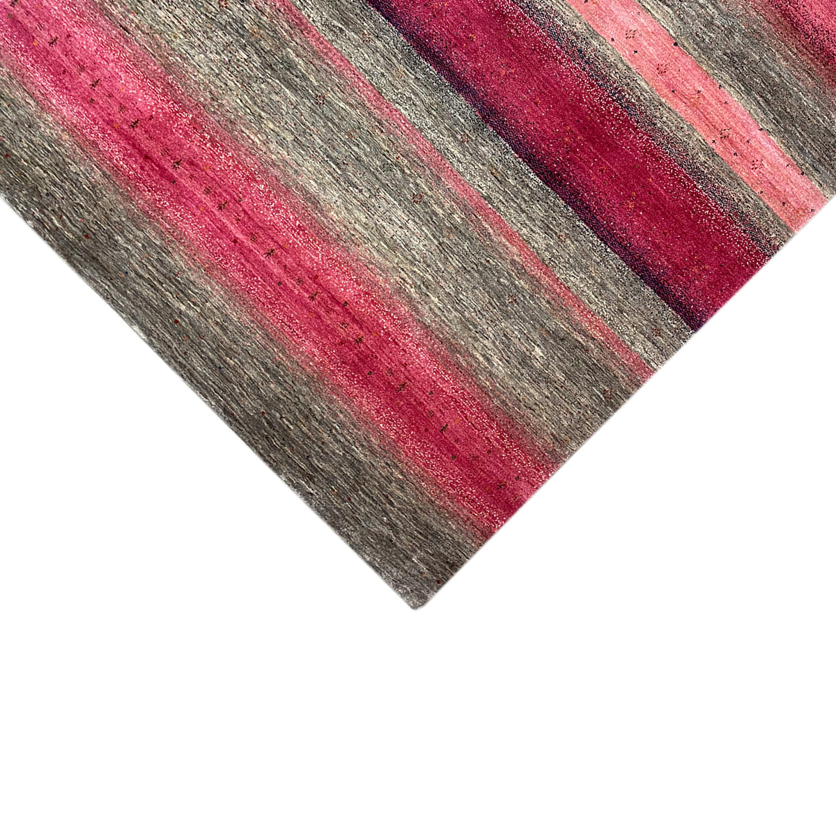 Gabbeh rug detail at the edge: pink and gray stripes