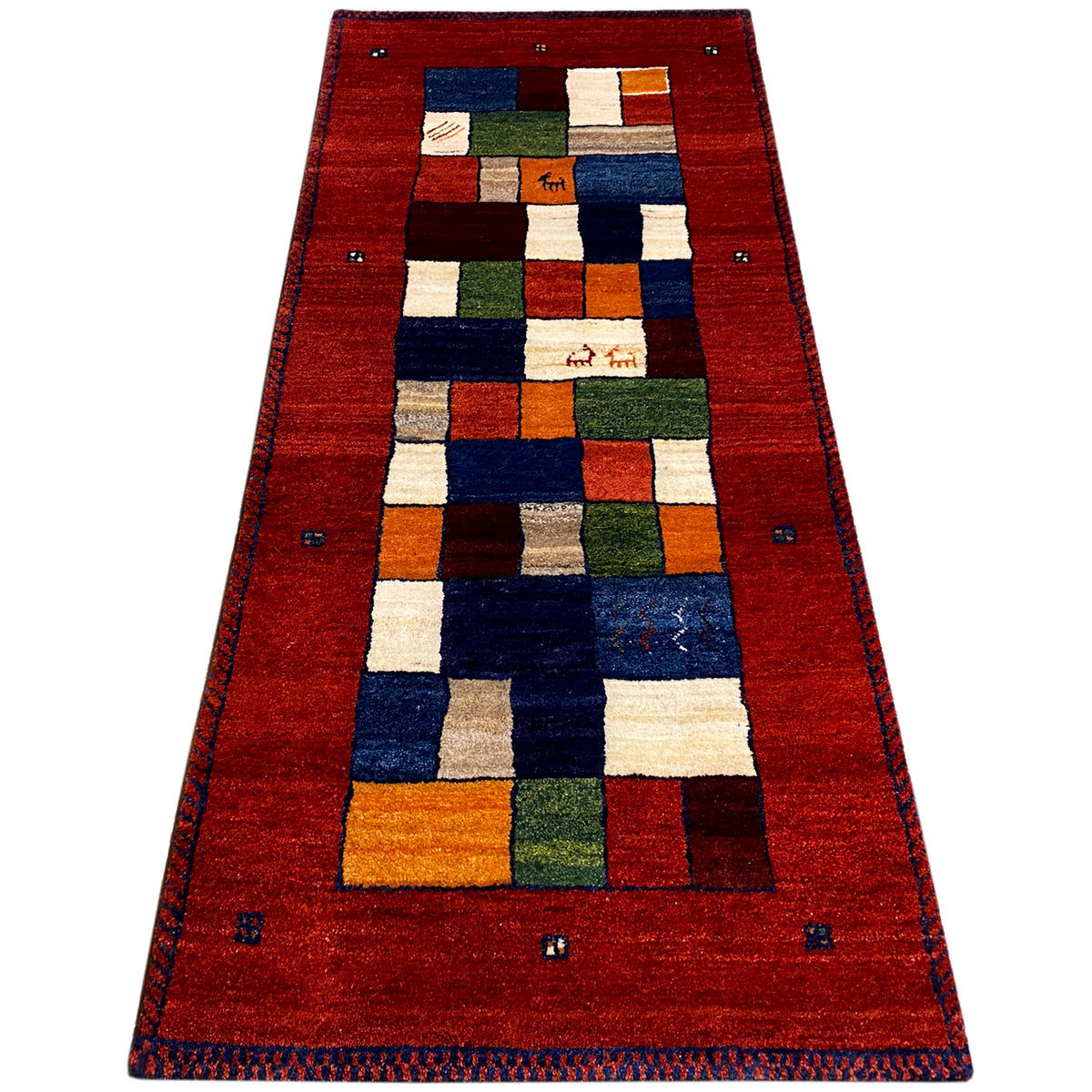 Red runner rug with a framed border and square patchwork pattern in blue and green