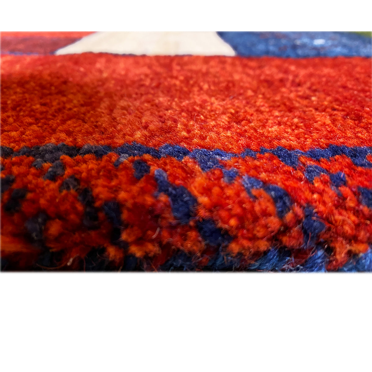 Detail of the pile surface of a red runner rug with colorful stripes and edges