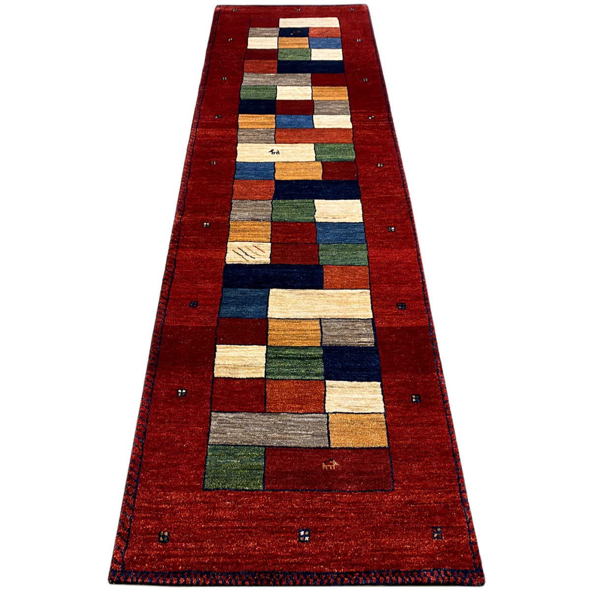 Red Gabbeh runner rug, elongated rectangular with a geometric central motif and border