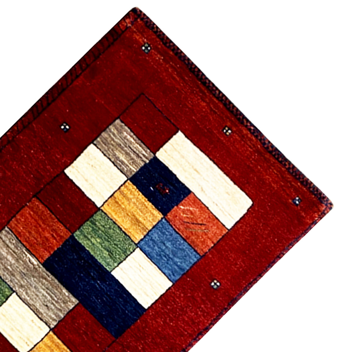 Corner of the Gabbeh runner rug: red border with multicolored square design