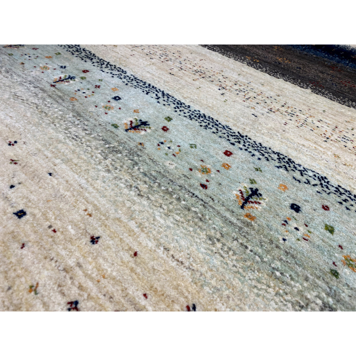Close-up: Gabbeh rug with delicate dot and jewelry motifs in beige and blue