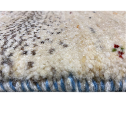 Close-up of the carpet edge: fluffy pile, beige with a blue border