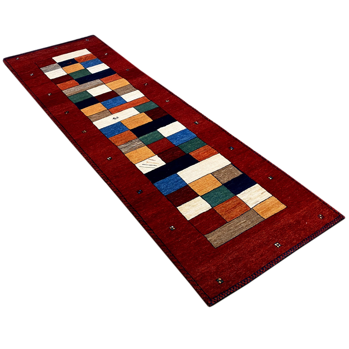 Red Gabbeh runner rug with patchwork motifs and a dark border with tassels
