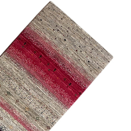 Close-up of a Gabbeh runner rug: greige stripes with a burgundy central section